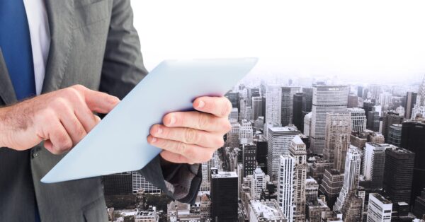 executive-with-tablet-buildings-background
