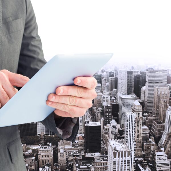 executive-with-tablet-buildings-background